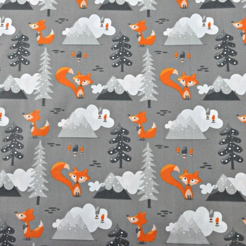 Cotton orange foxes in the mountains on a gray background