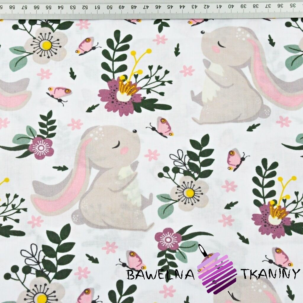 Cotton rabbits on a green-purple meadow on a white background