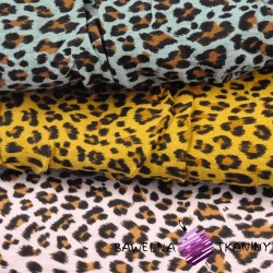 Cotton muslin double gauze with panther pattern on a mustard background