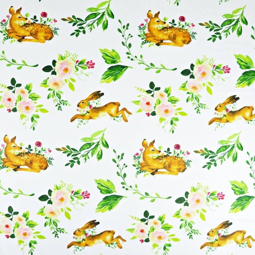 Cotton deer with hares and green leaves on a white background