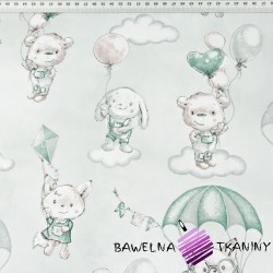Cotton cuddly toys with pink-green parachutes on a light gray background
