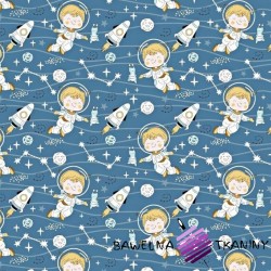 Cotton cosmonauts with rockets on a denim background