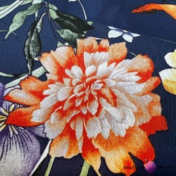 Patterned cotton satin with orange flowers on a navy blue background