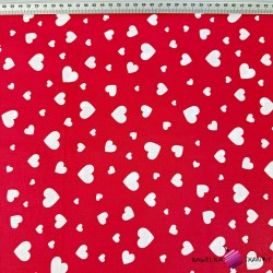 Cotton small and large white hearts on an amaranth background