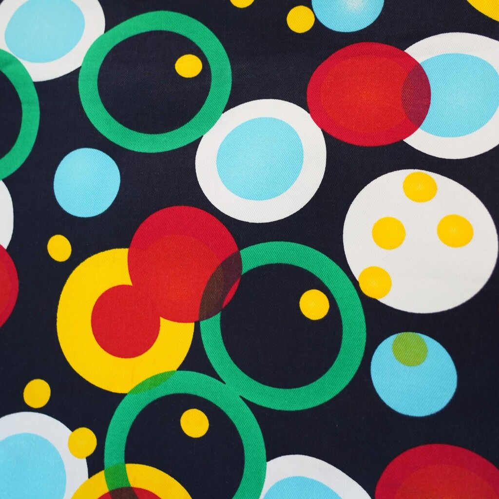 Sun lounger fabric with colorful circles on a navy blue background