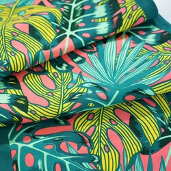 Sun lounger fabric with monstera leaves on a coral background