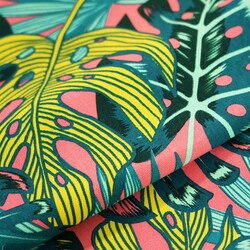 Sun lounger fabric with monstera leaves on a coral background