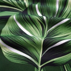 Patterned cotton satin with large green leaves with glitter