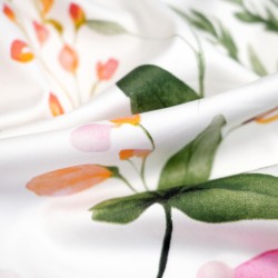 Patterned cotton satin with pink apricot violet field flowers on a white background