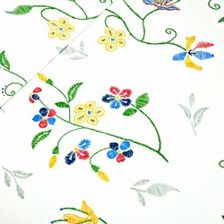 Cotton flowers embroidered on white background