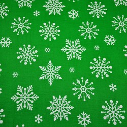 Cotton big white snowflake on green background