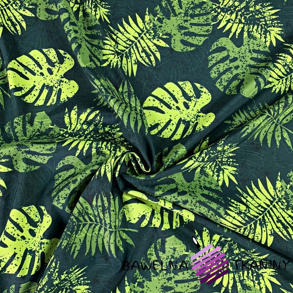 waterproof fabric green leaves of monstera on a dark green background