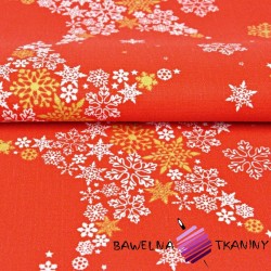 Decorative fabric white and gold stars in snowflakes on a red background