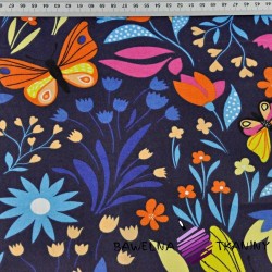 Cotton colorful butterflies on the meadow on the navy blue background