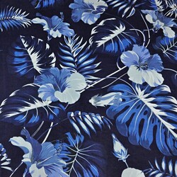 Cotton leaves with blue hibiscus flower on navy background